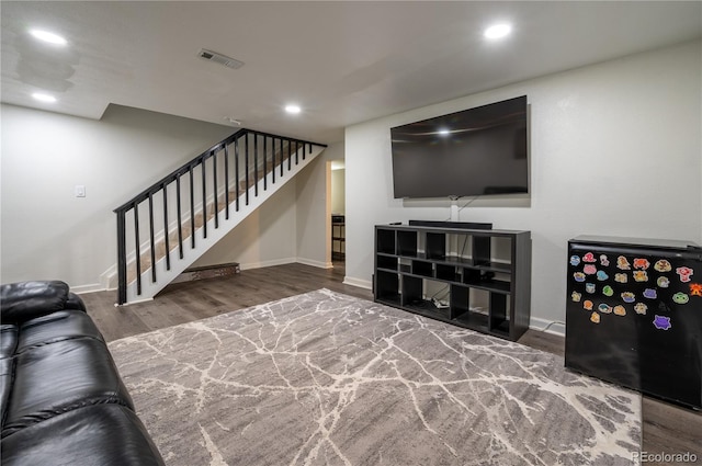 living room with recessed lighting, wood finished floors, visible vents, baseboards, and stairway