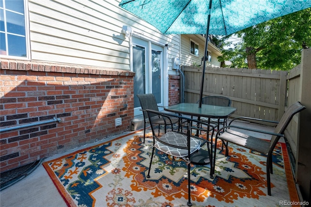 view of patio / terrace featuring outdoor dining area and fence