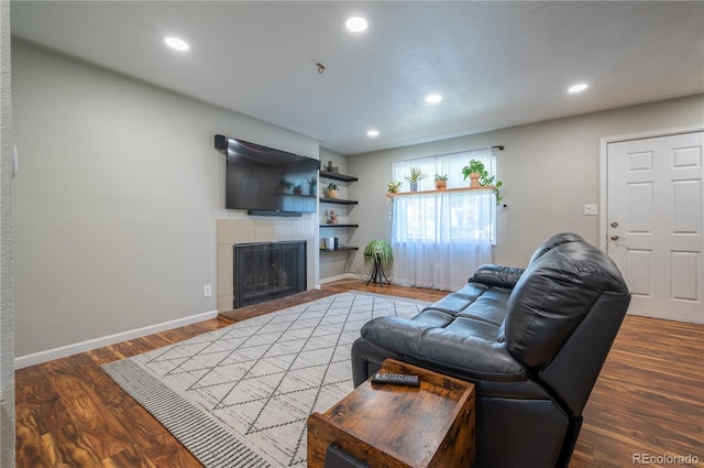 4673 S Lowell Blvd, Denver, CO 80236 - living area featuring baseboards, a tiled fireplace, recessed lighting, and wood finished floors