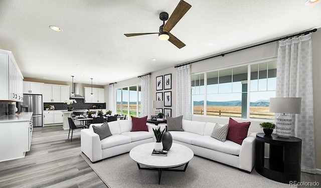9186 Telluride Ct, Commerce City, CO 80022 - living room featuring a ceiling fan, light wood finished floors, and recessed lighting