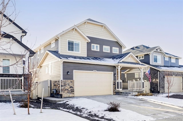 view of front of home with covered porch, central AC unit, and a garage