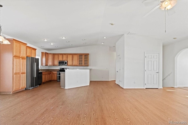51 W 6th Pl, Byers, CO 80103 - kitchen with stainless steel appliances, light wood-type flooring, arched walkways, vaulted ceiling, and open floor plan