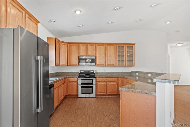 51 W 6th Pl, Byers, CO 80103 - kitchen with stainless steel appliances, a peninsula, vaulted ceiling, dark wood finished floors, and glass insert cabinets