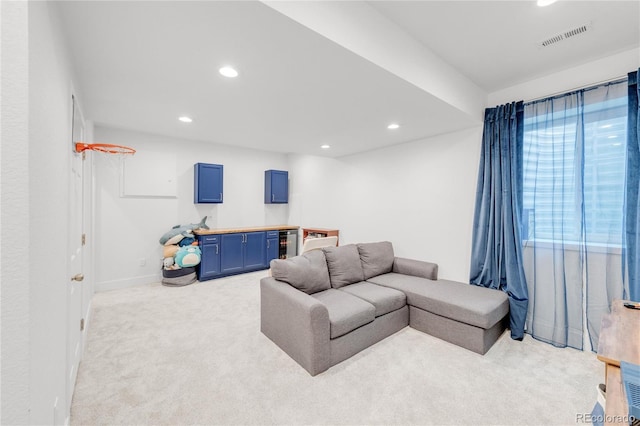 carpeted living room featuring wine cooler