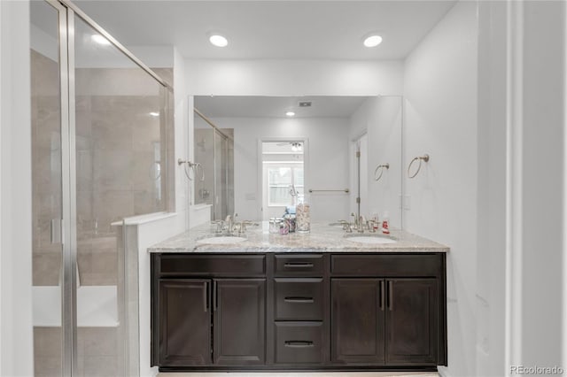 bathroom featuring vanity and an enclosed shower