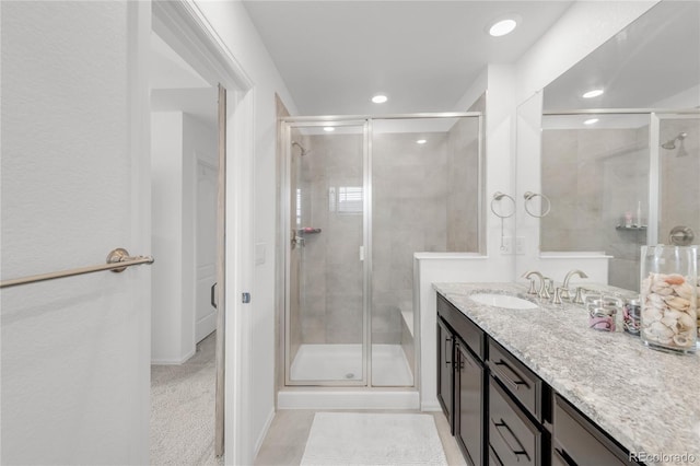 bathroom featuring vanity and an enclosed shower