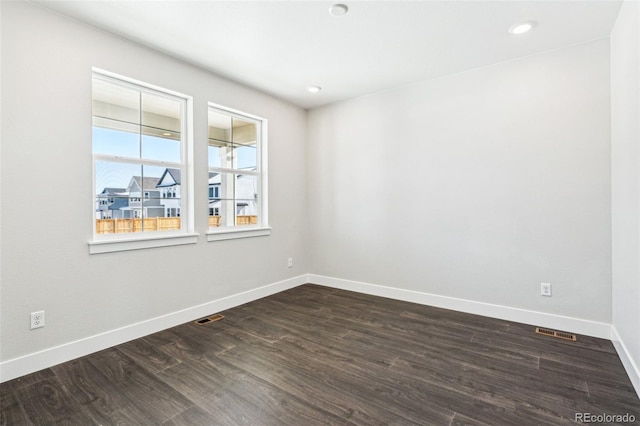 unfurnished room featuring dark wood-type flooring