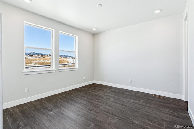 spare room featuring dark hardwood / wood-style flooring