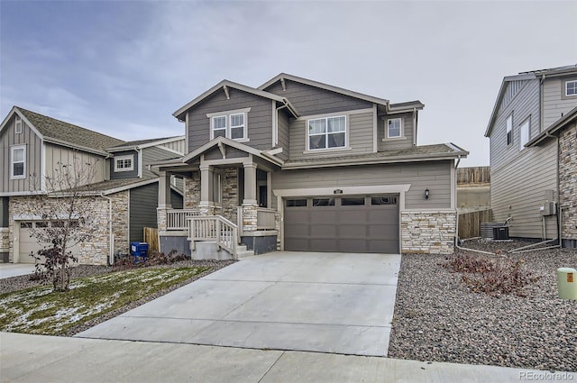 view of front of house featuring a garage and central AC