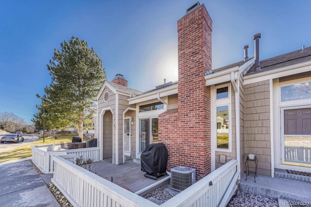 view of patio / terrace featuring area for grilling and central air condition unit