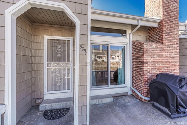 property entrance featuring a chimney