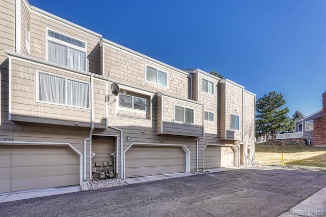 view of property featuring a garage and driveway