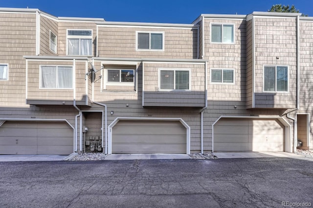 view of property with an attached garage and driveway