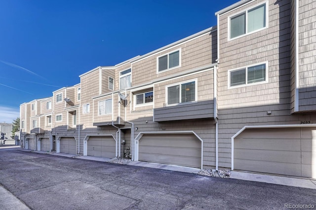 exterior space with an attached garage and a residential view