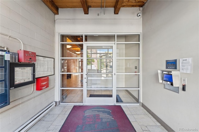 view of exterior entry featuring baseboard heating