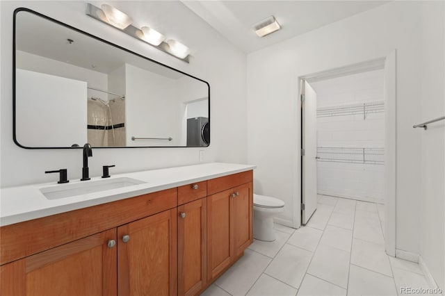 bathroom featuring vanity, toilet, and tile patterned flooring