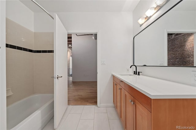 bathroom with tile patterned floors, vanity, and tiled shower / bath combo