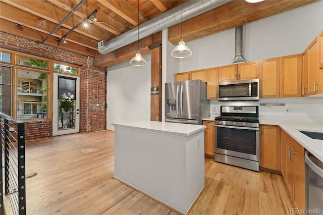 kitchen with light hardwood / wood-style flooring, decorative light fixtures, brick wall, beamed ceiling, and stainless steel appliances