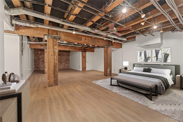 bedroom with decorative columns and hardwood / wood-style flooring