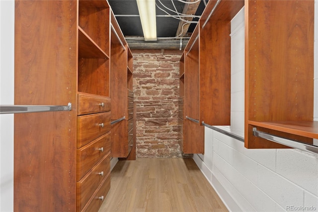 walk in closet featuring light hardwood / wood-style flooring