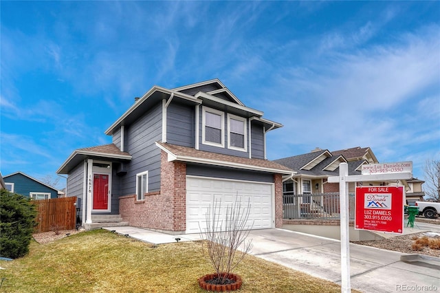 view of front of property with a garage and a front lawn