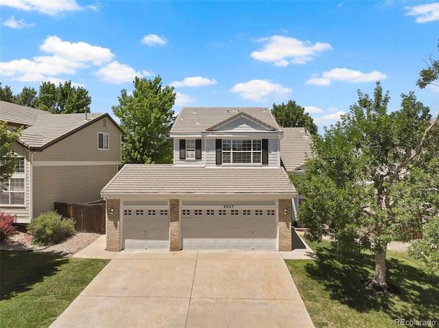 4807 S Killarney Ct, Aurora, CO 80015 - traditional home featuring brick siding, concrete driveway, a tiled roof, and an attached garage