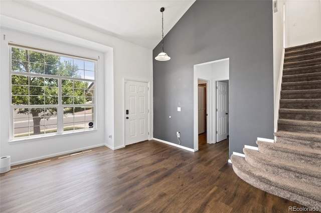 4807 S Killarney Ct, Aurora, CO 80015 - foyer entrance with high vaulted ceiling, stairs, and dark wood-style flooring