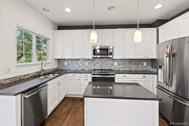 4807 S Killarney Ct, Aurora, CO 80015 - kitchen with appliances with stainless steel finishes, backsplash, dark wood finished floors, white cabinets, and recessed lighting