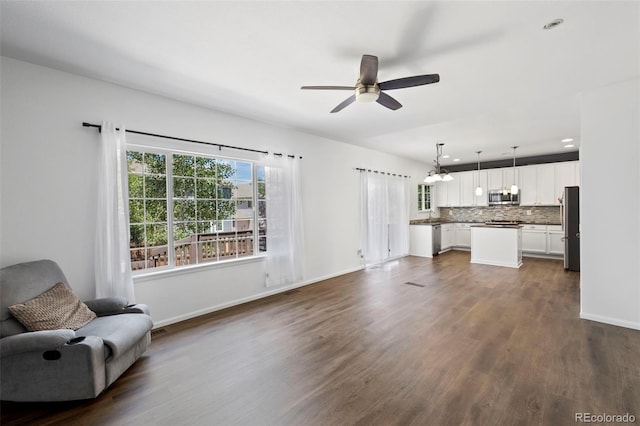 4807 S Killarney Ct, Aurora, CO 80015 - unfurnished living room featuring ceiling fan, dark wood-style flooring, and a chandelier
