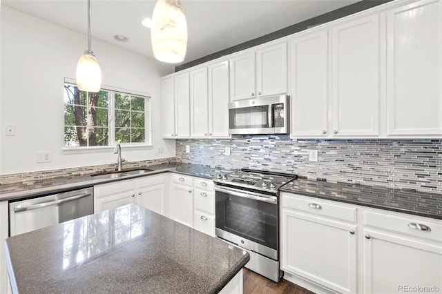4807 S Killarney Ct, Aurora, CO 80015 - kitchen featuring stainless steel appliances, white cabinets, tasteful backsplash, and dark stone countertops