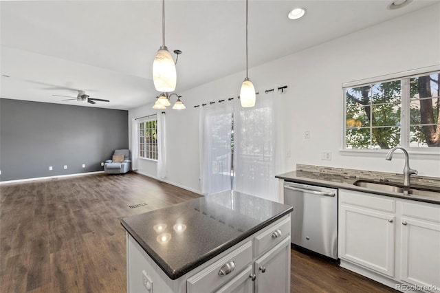 4807 S Killarney Ct, Aurora, CO 80015 - kitchen with stainless steel dishwasher, a ceiling fan, white cabinets, dark wood-type flooring, and open floor plan