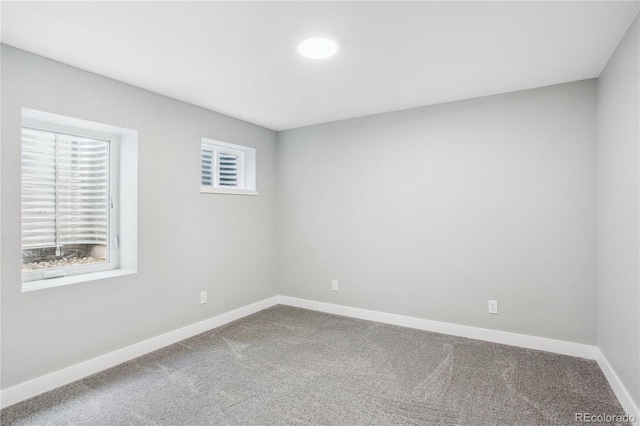 carpeted empty room with baseboards