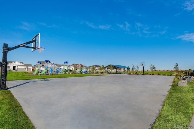 view of basketball court with a lawn and a playground