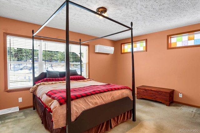 carpeted bedroom with an AC wall unit and a textured ceiling