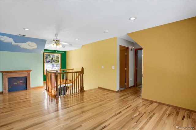 interior space featuring light wood-type flooring and ceiling fan