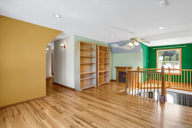 additional living space featuring ceiling fan, hardwood / wood-style floors, and lofted ceiling