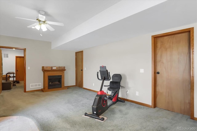 exercise room featuring light carpet and ceiling fan