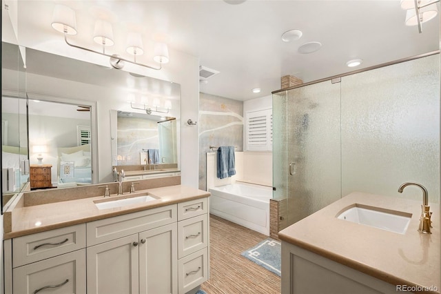 full bathroom featuring two vanities, a sink, and a stall shower