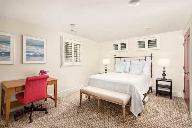carpeted bedroom featuring baseboards and visible vents