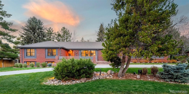 prairie-style house with a front lawn and brick siding