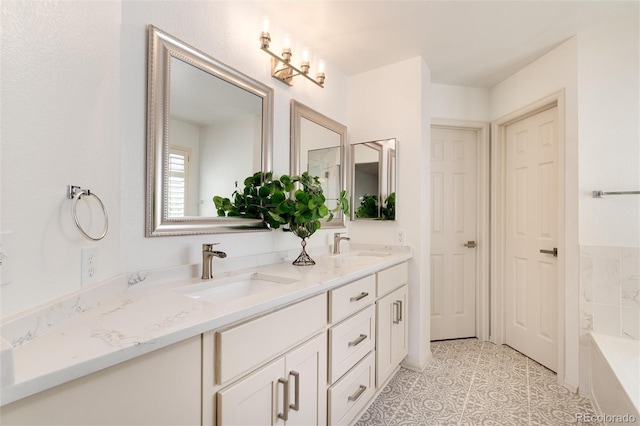 bathroom featuring tile patterned floors, a bathing tub, vanity, and an inviting chandelier