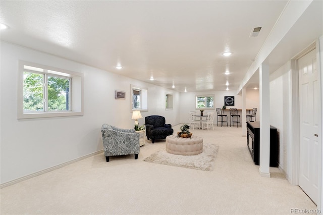 living area featuring light colored carpet