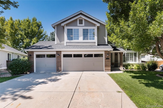 view of front facade with a front yard and a garage