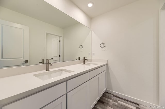 bathroom featuring hardwood / wood-style flooring and vanity