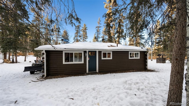 view of snow covered back of property