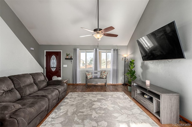 living room with wood-type flooring, vaulted ceiling, and ceiling fan