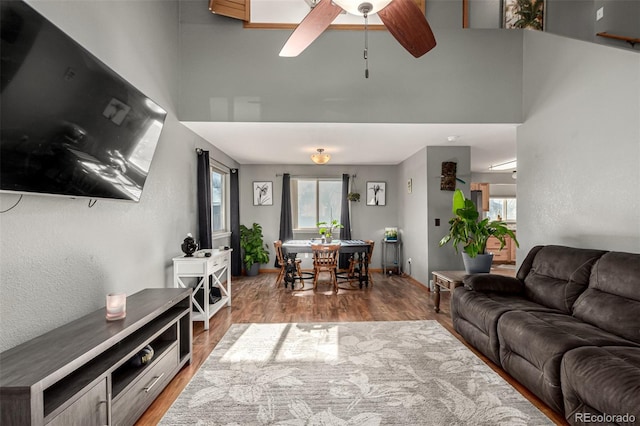 living room featuring ceiling fan and wood-type flooring