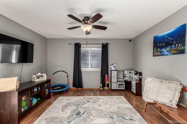 game room featuring ceiling fan and dark hardwood / wood-style flooring