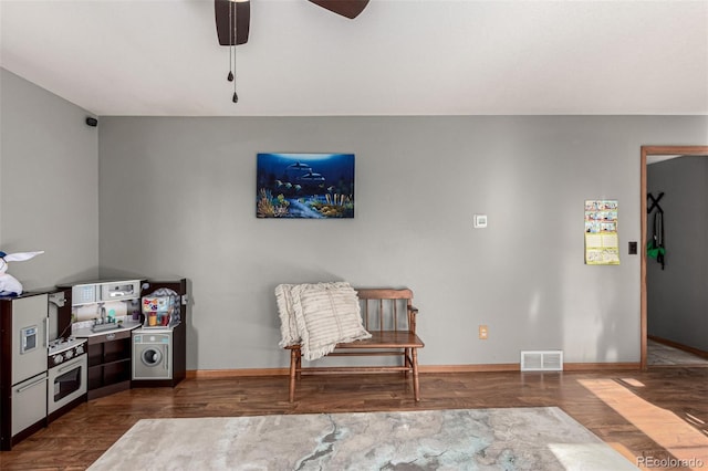 living area with hardwood / wood-style flooring and ceiling fan