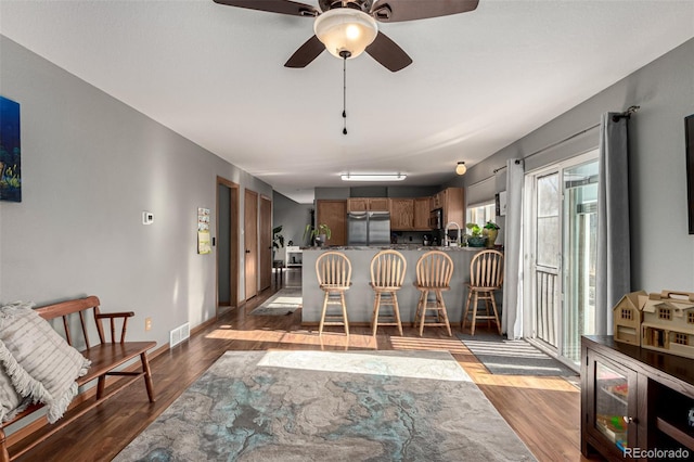 dining room featuring dark hardwood / wood-style floors, ceiling fan, and sink